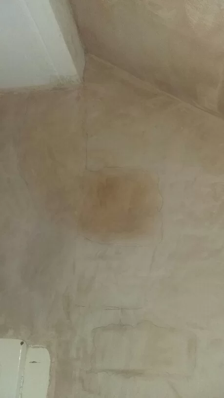 dark patches on attic chimney breast wall