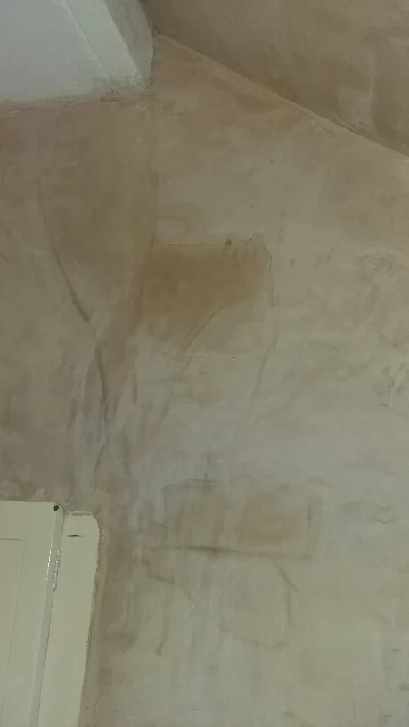 dark patches on attic chimney breast wall