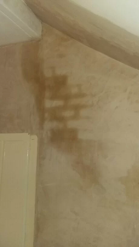 dark patches on attic chimney breast wall