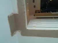 Repairing a water damaged dot and dabbed plasterboard wall.