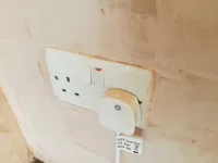 Should plasterer have removed socket/switch covers?